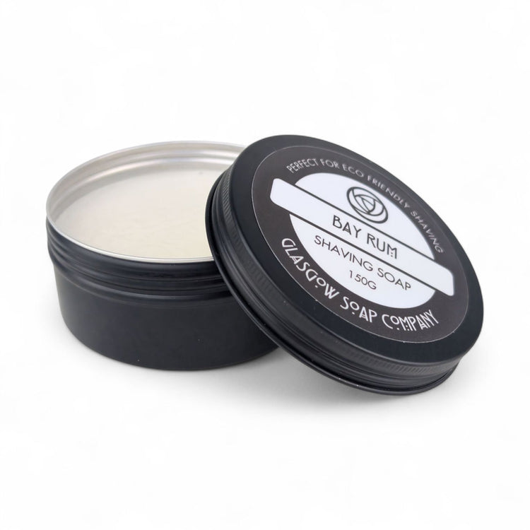 Shaving soap in a black container with lid on a white background