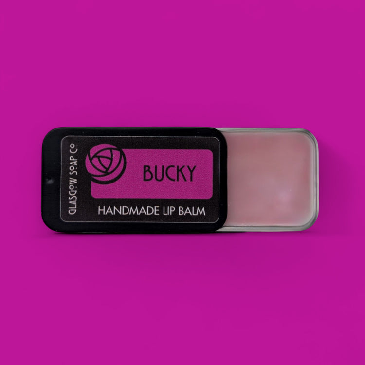 Bucky handmade lip balm on a pink background