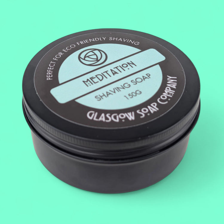 Shaving soap container with 'Meditation' and 'Glasgow Soap Company' branding on a teal background
