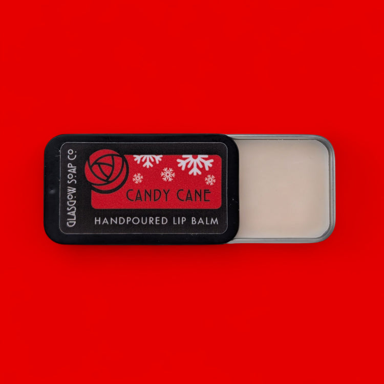Handpoured lip balm with 'Candy Cane' flavor on a red background