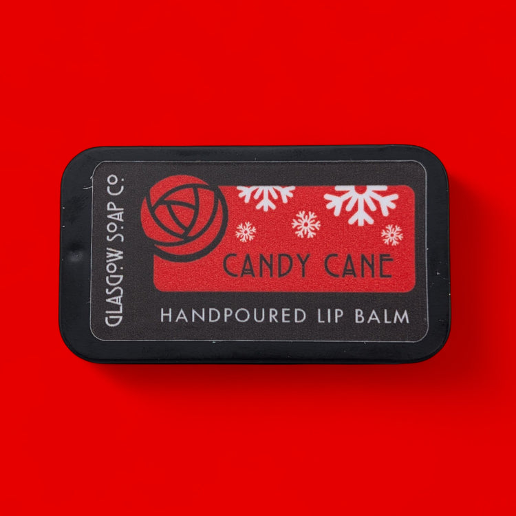 Handpoured lip balm labeled 'Candy Cane' on a red background