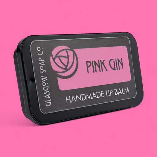 Handmade lip balm packaging with 'Pink Gin' branding on a pink background