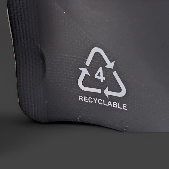Recyclable symbol on a black surface