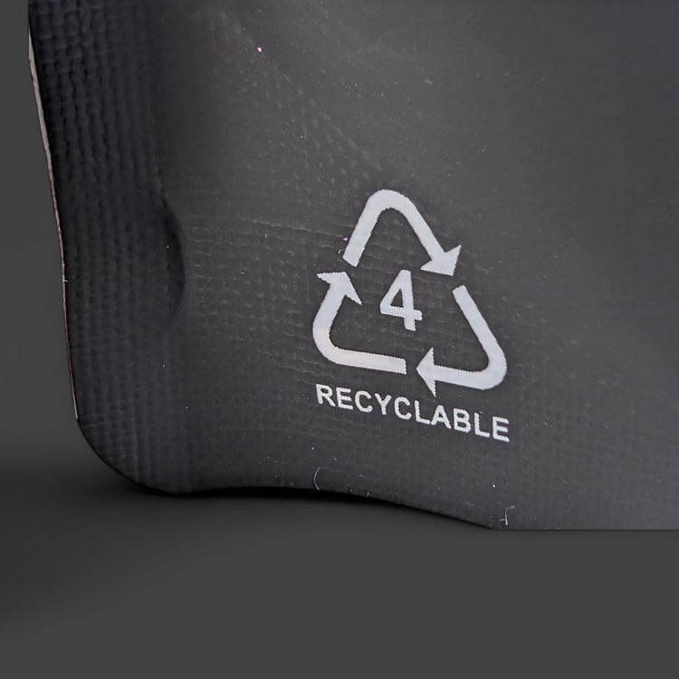 Recyclable symbol on a black surface