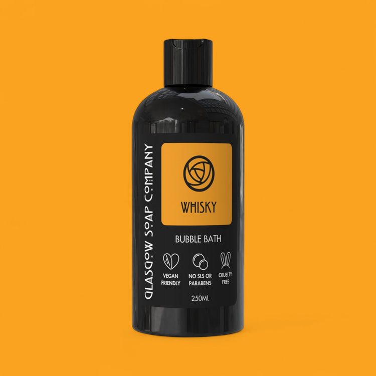 Black bottle of Glasgow Soap Company whisky bubble bath on an orange background