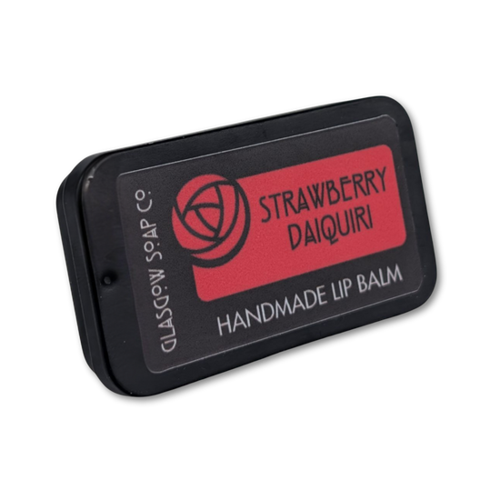 Handmade lip balm packaging with 'Strawberry Daiquiri' flavor on a white background