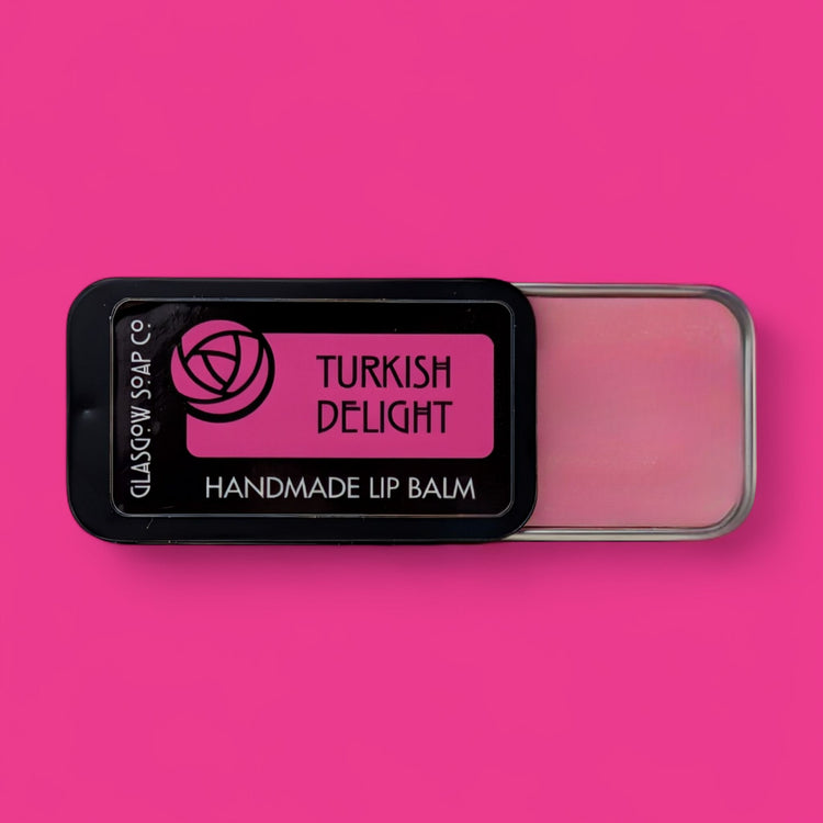 Handmade lip balm in a tin with 'Turkish Delight' label on a pink background