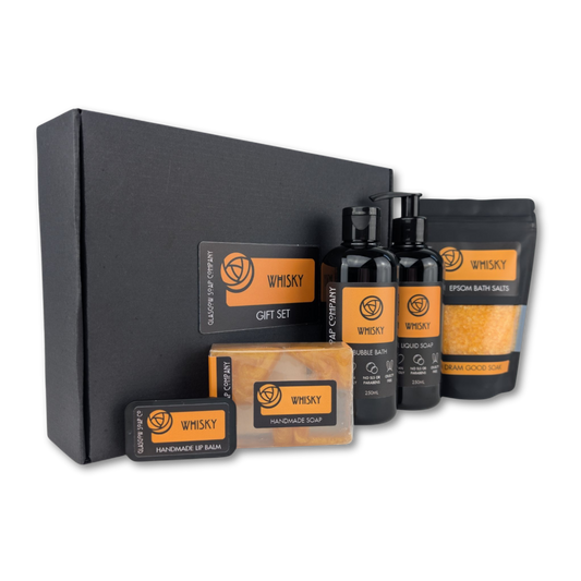 Whisky-themed gift set with bottles, soap, and packaging on a white background