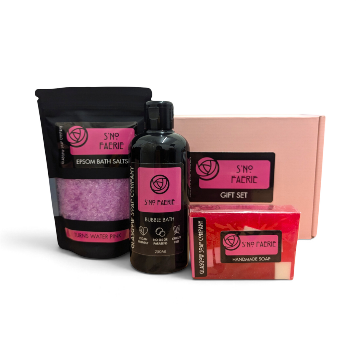 Glasgow Soap Company Ltd S'NO FAERIE bath gift set with pink Epsom salts, bubble bath, handmade soap, and petals.
