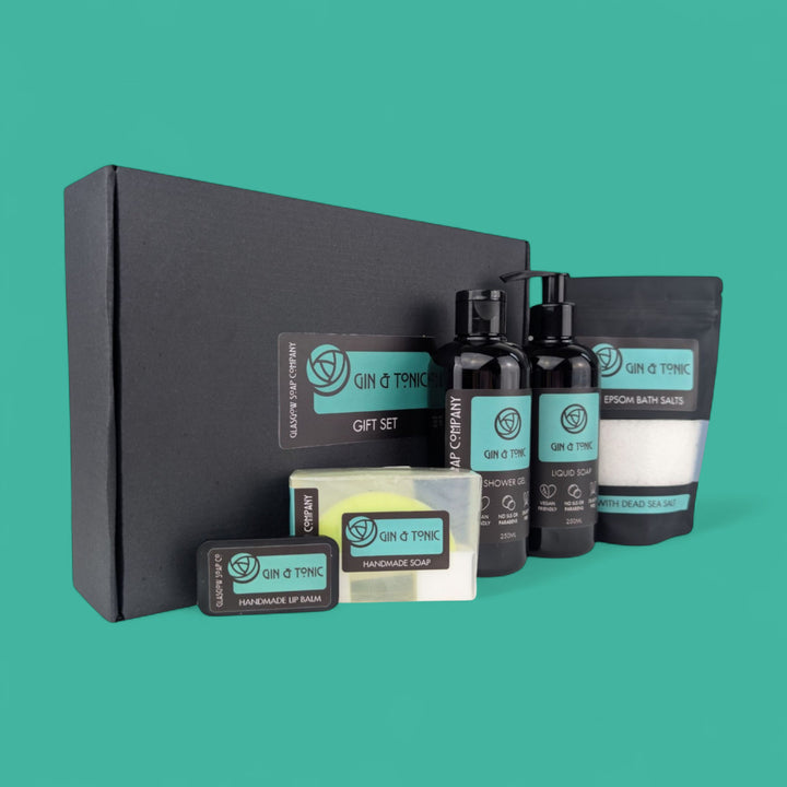 Gin & Tonic gift set with various products on a teal background
