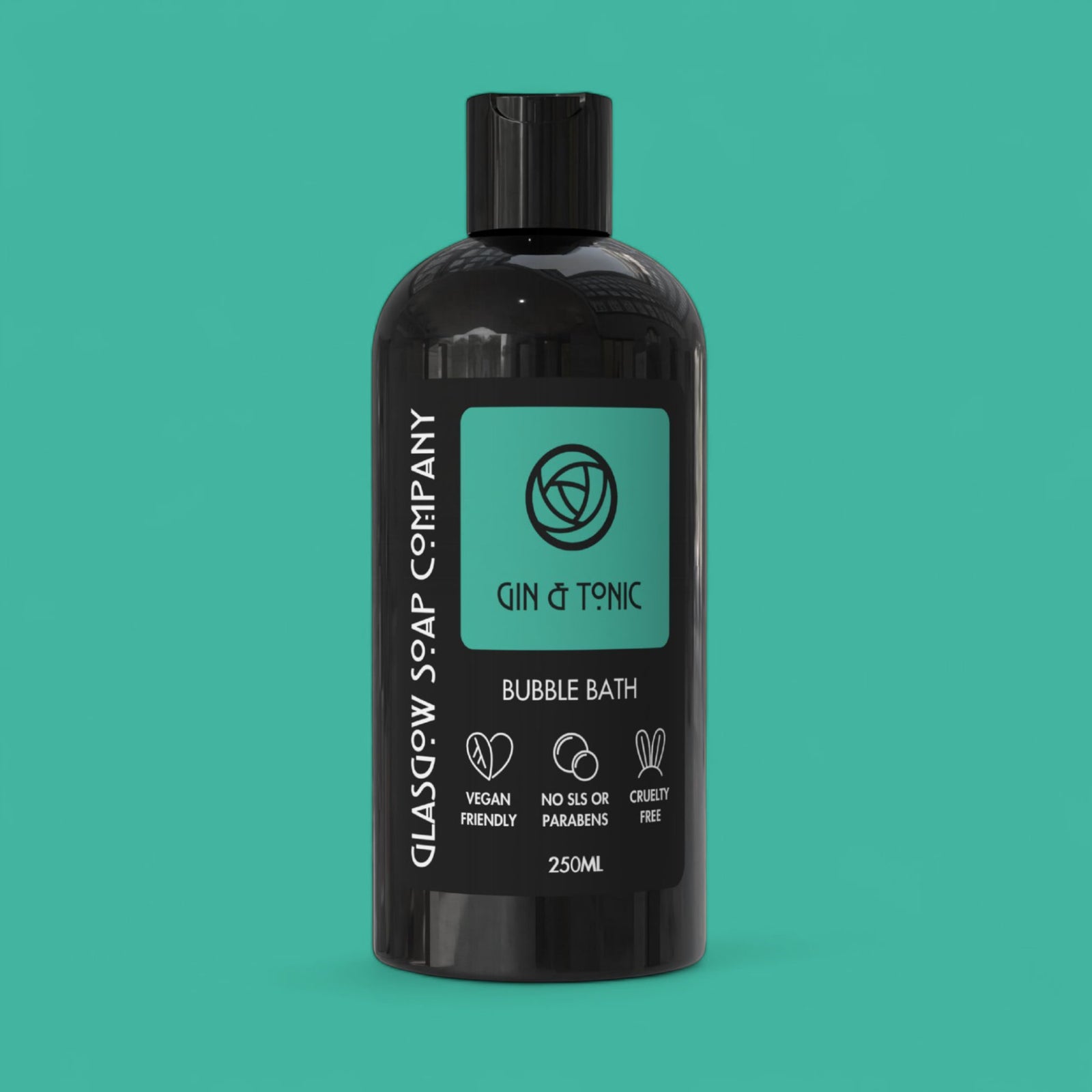 Black bottle of Gin & Tonic bubble bath from Glasgow Soap Company on a teal background