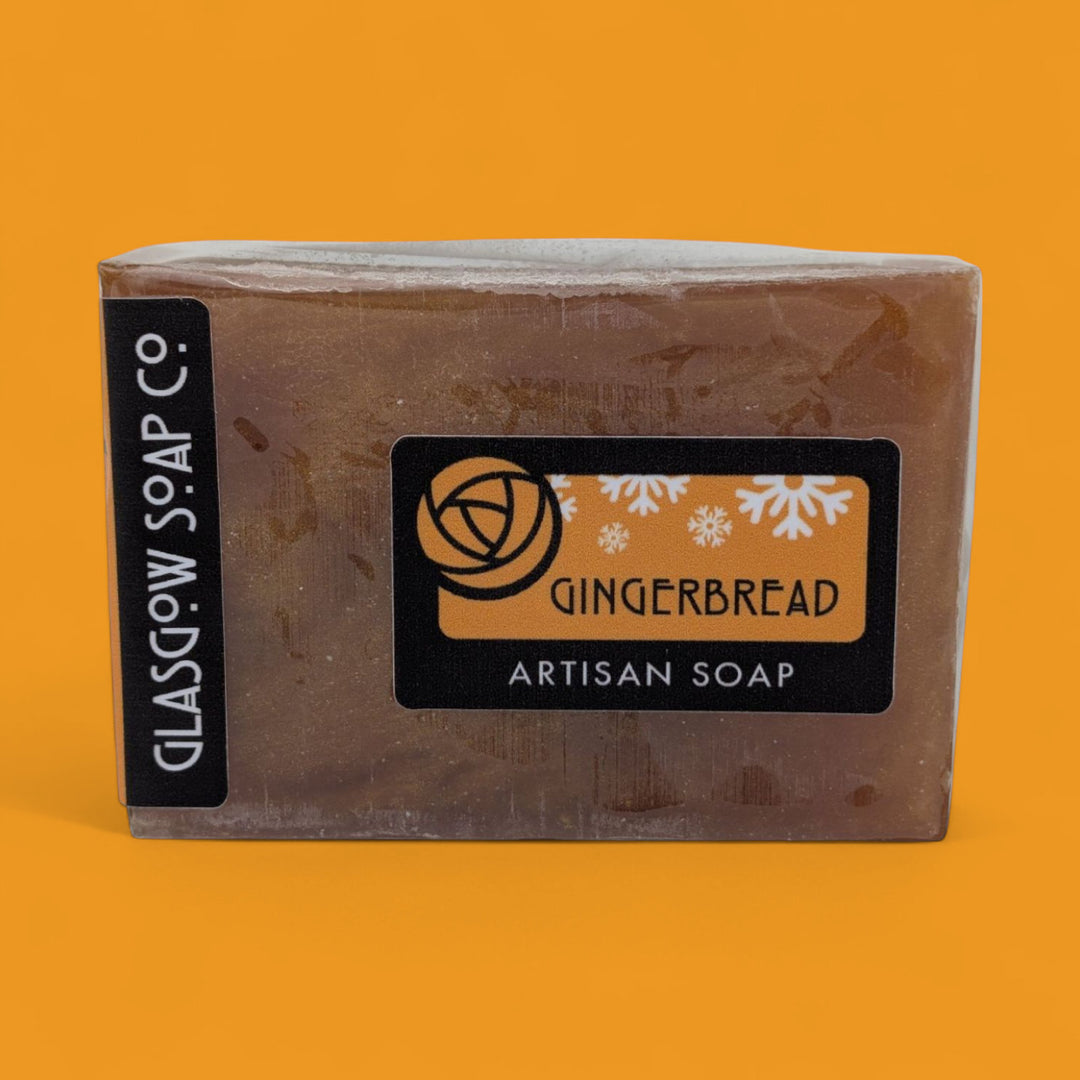 Bar of gingerbread artisan soap with 'Glasgow Soap Co.' branding on an orange background