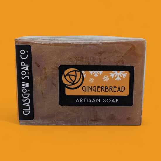 Bar of gingerbread artisan soap with 'Glasgow Soap Co.' branding on an orange background