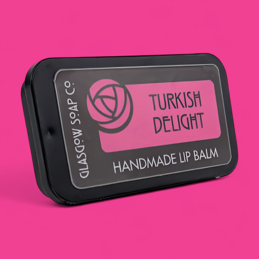 Handmade lip balm packaging with 'Turkish Delight' flavor on a pink background