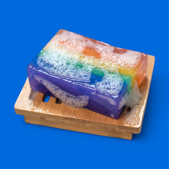 Colorful soap on a wooden stand with a blue background