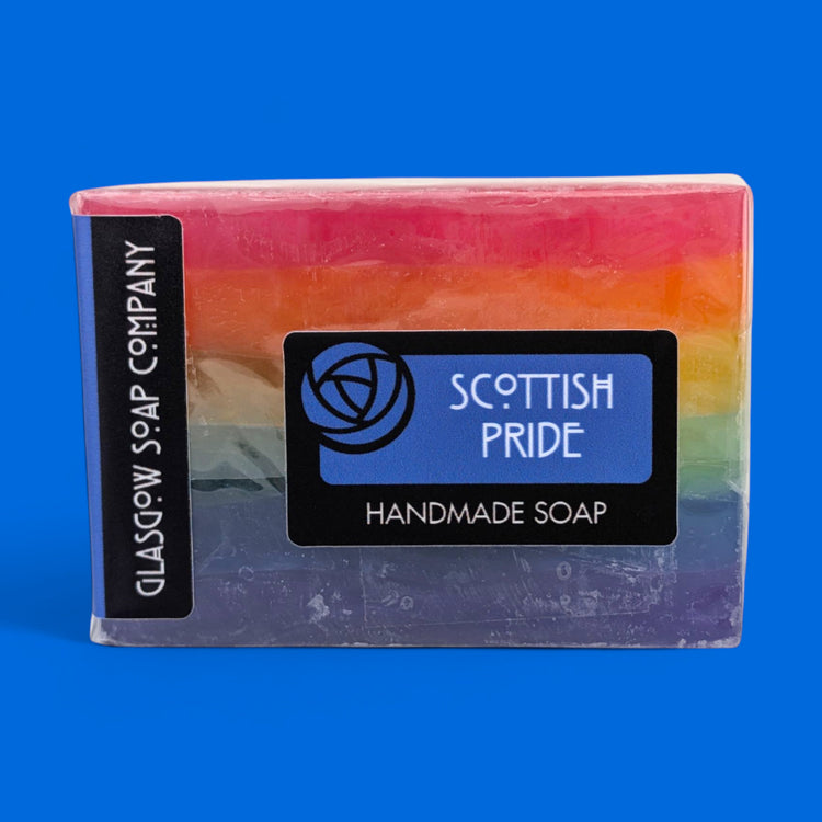 Rainbow-colored soap bar with 'Scottish Pride' and 'Glasgow Soap Company' labels on a blue background