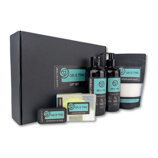 Gin & Tonic gift set with various products including bottles, soap, and bath salts on a white background.