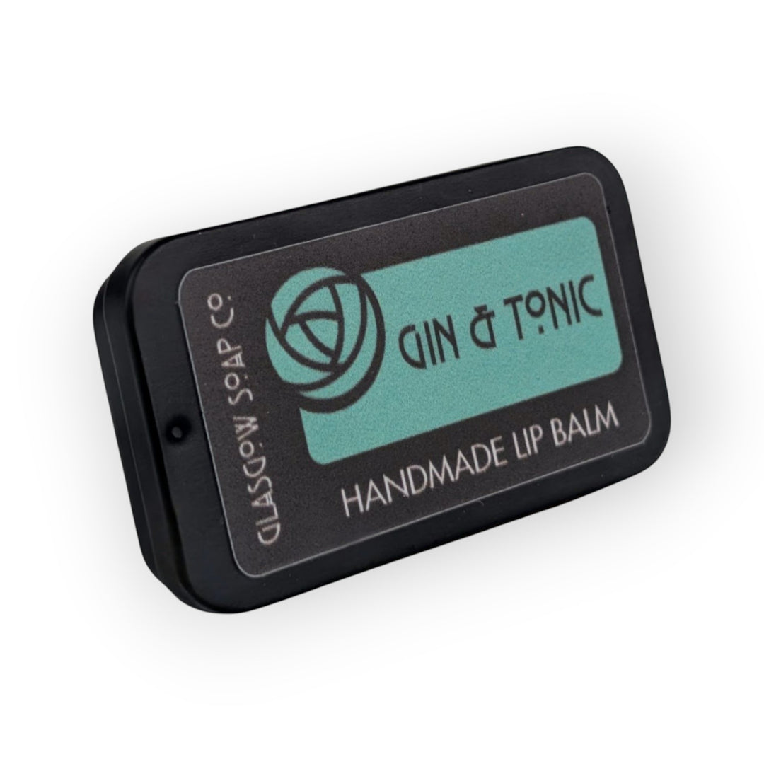 Glasgow Soap Company Ltd Gin &amp; Tonic handmade lip balm in a black tin with a teal label.