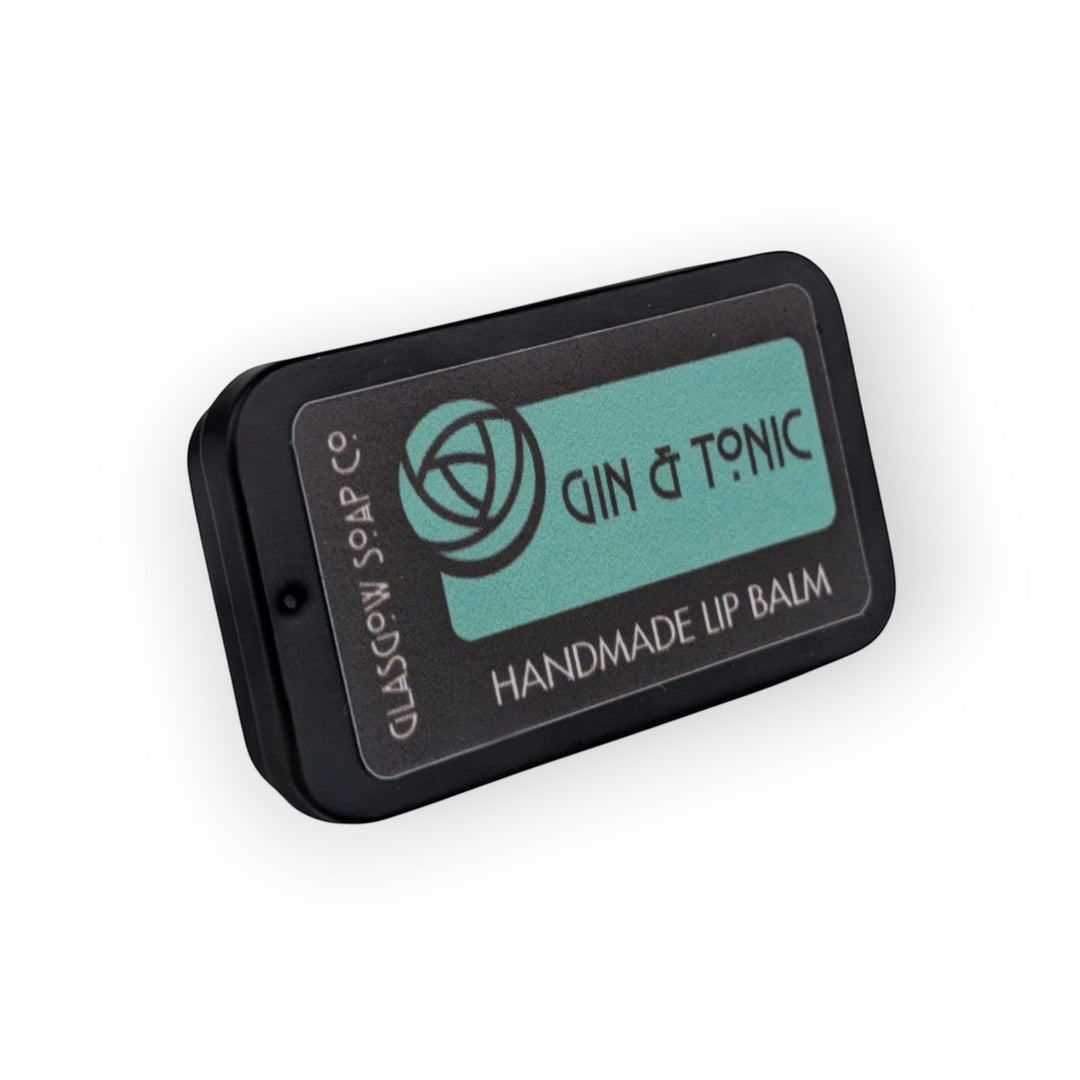 Glasgow Soap Company Ltd Gin &amp; Tonic handmade lip balm in a black tin with a teal label.