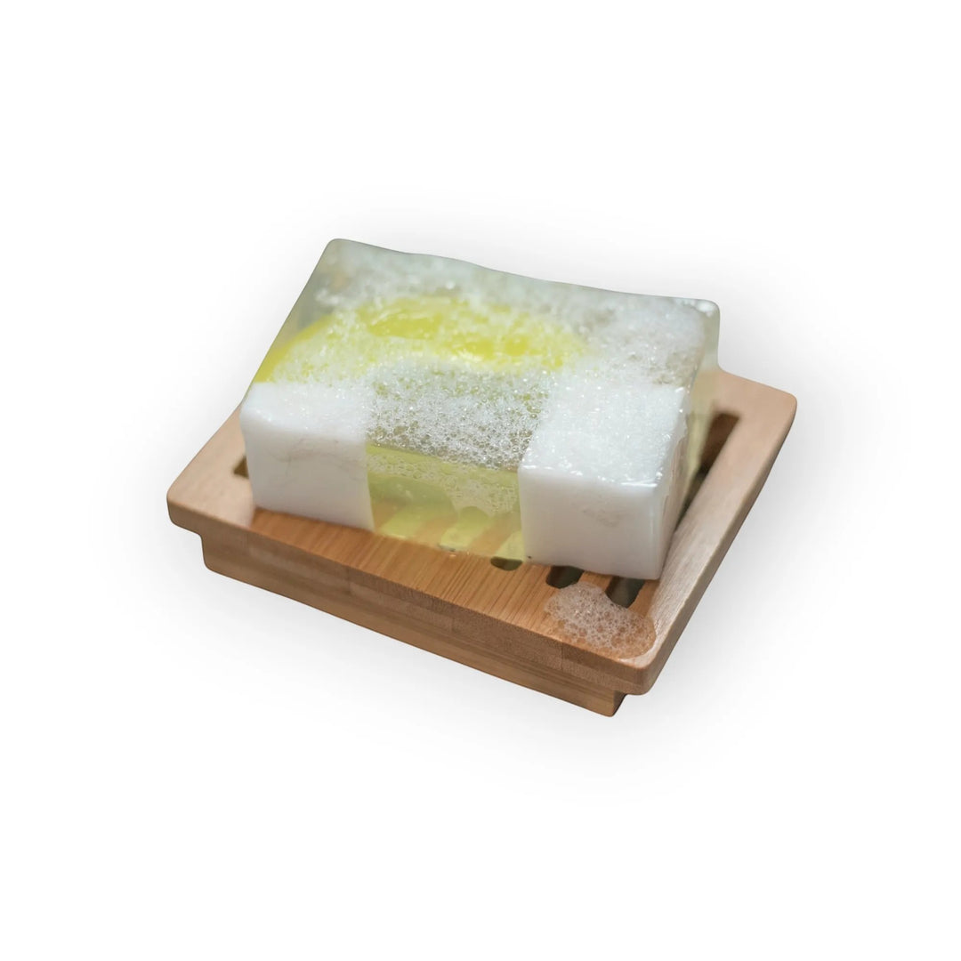 Glasgow Soap Company Ltd Gin &amp; Tonic handmade soap slice with white cubes and yellow centre on bamboo dish.