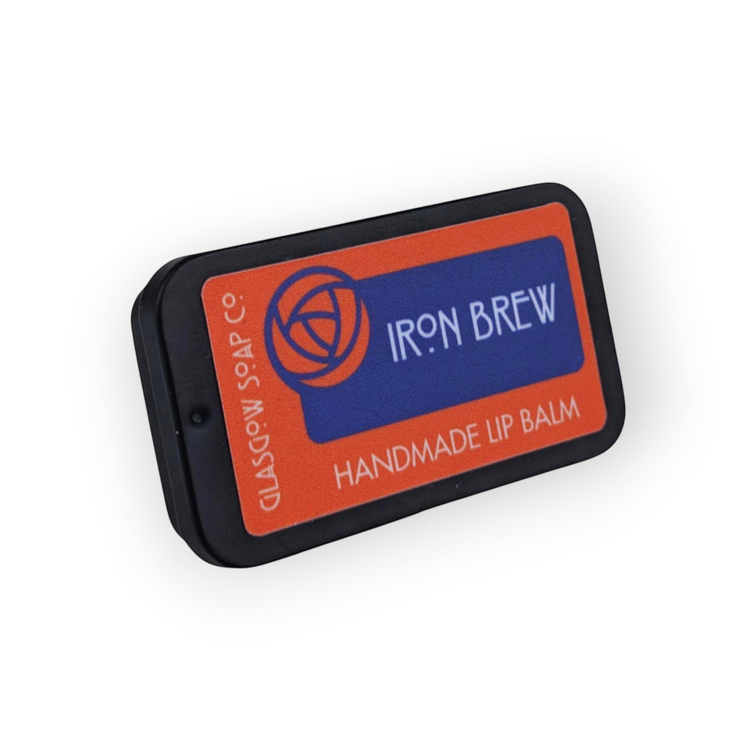 Glasgow Soap Company Ltd Iron Brew handmade lip balm in a black tin with orange and blue label.