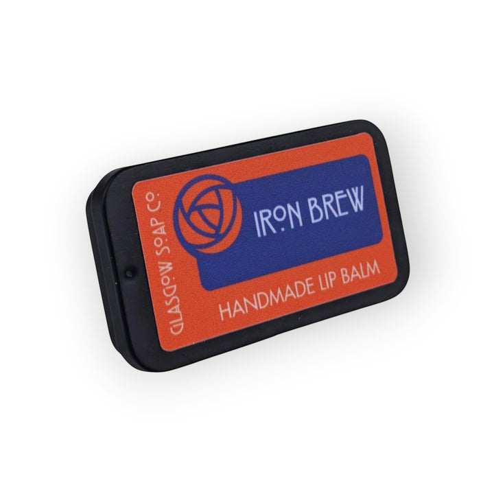 Glasgow Soap Company Ltd Iron Brew handmade lip balm in a black tin with orange and blue label.