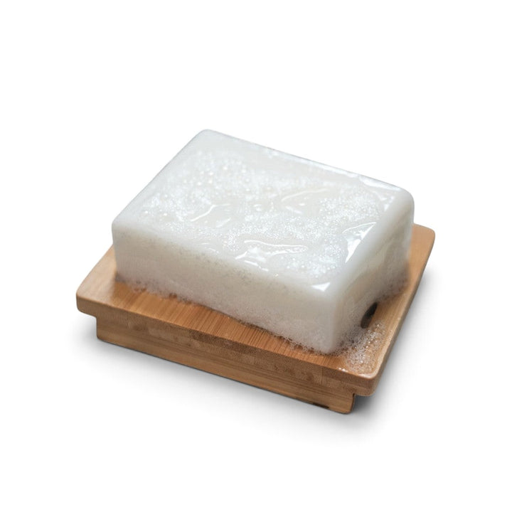 Glasgow Soap Company Ltd Bay Rum vegetable glycerine soap bar with lather on a wooden soap dish
