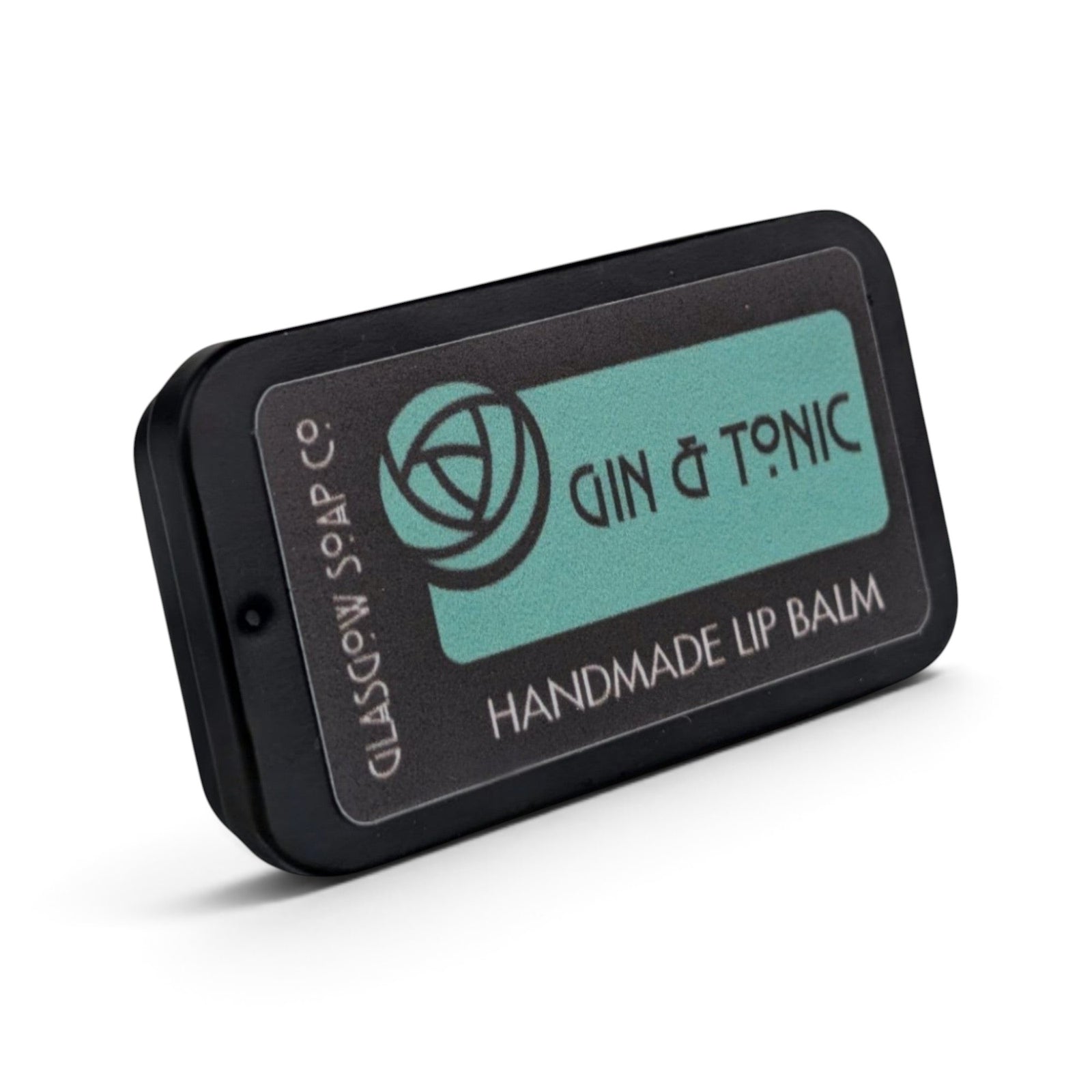 Glasgow Soap Company Ltd Gin & Tonic lip balm in a black sliding tin with a teal label featuring botanical branding.