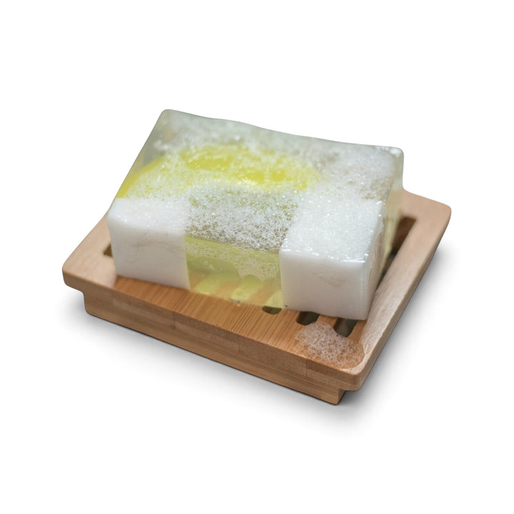 Glasgow Soap Company Ltd gin and tonic soap bar with lime slice and ice cube design on a wooden soap dish