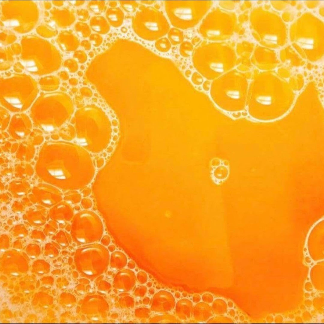 Glasgow Soap Company Ltd Iron Brew bath salts creating vibrant orange bubbly water for a relaxing soak