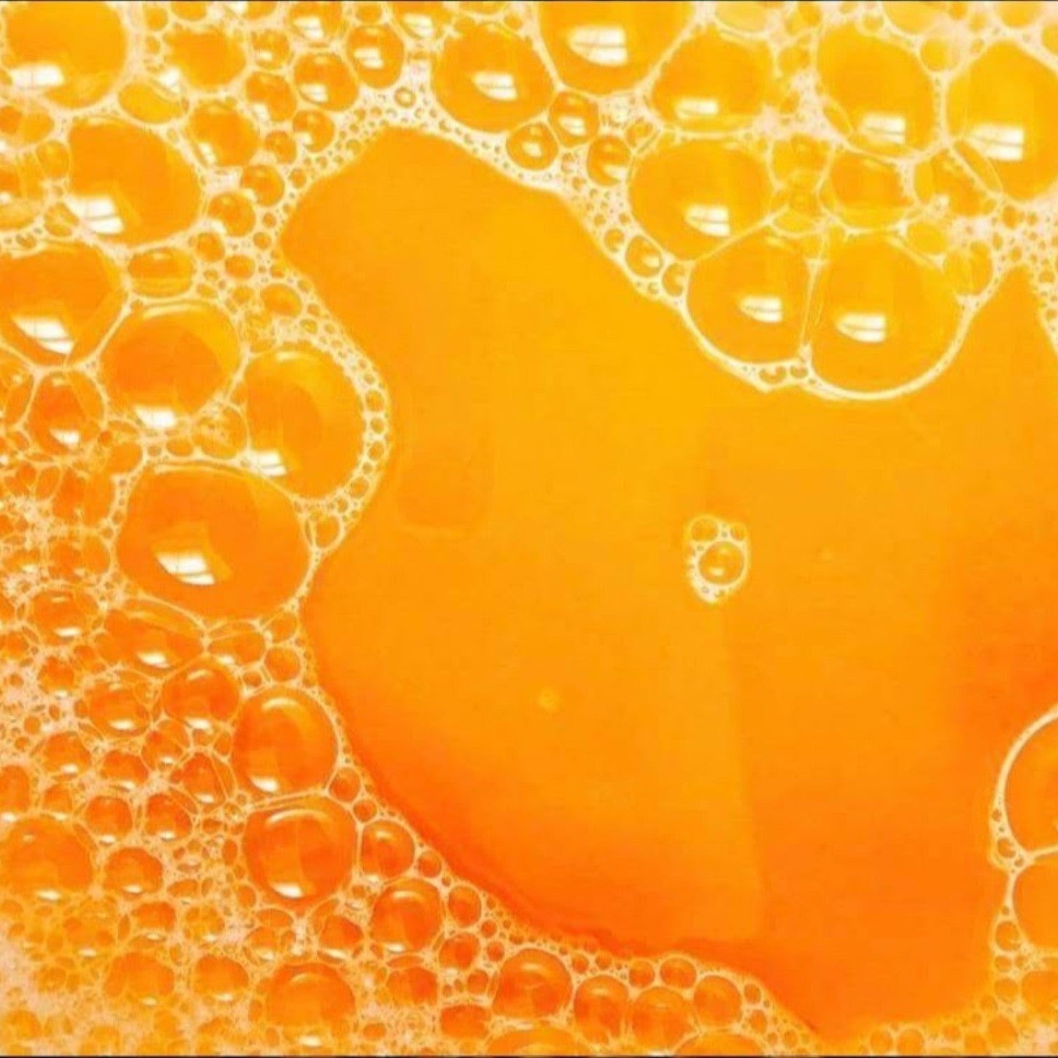 Glasgow Soap Company Ltd Iron Brew bath salts creating vibrant orange bubbly water for a relaxing soak