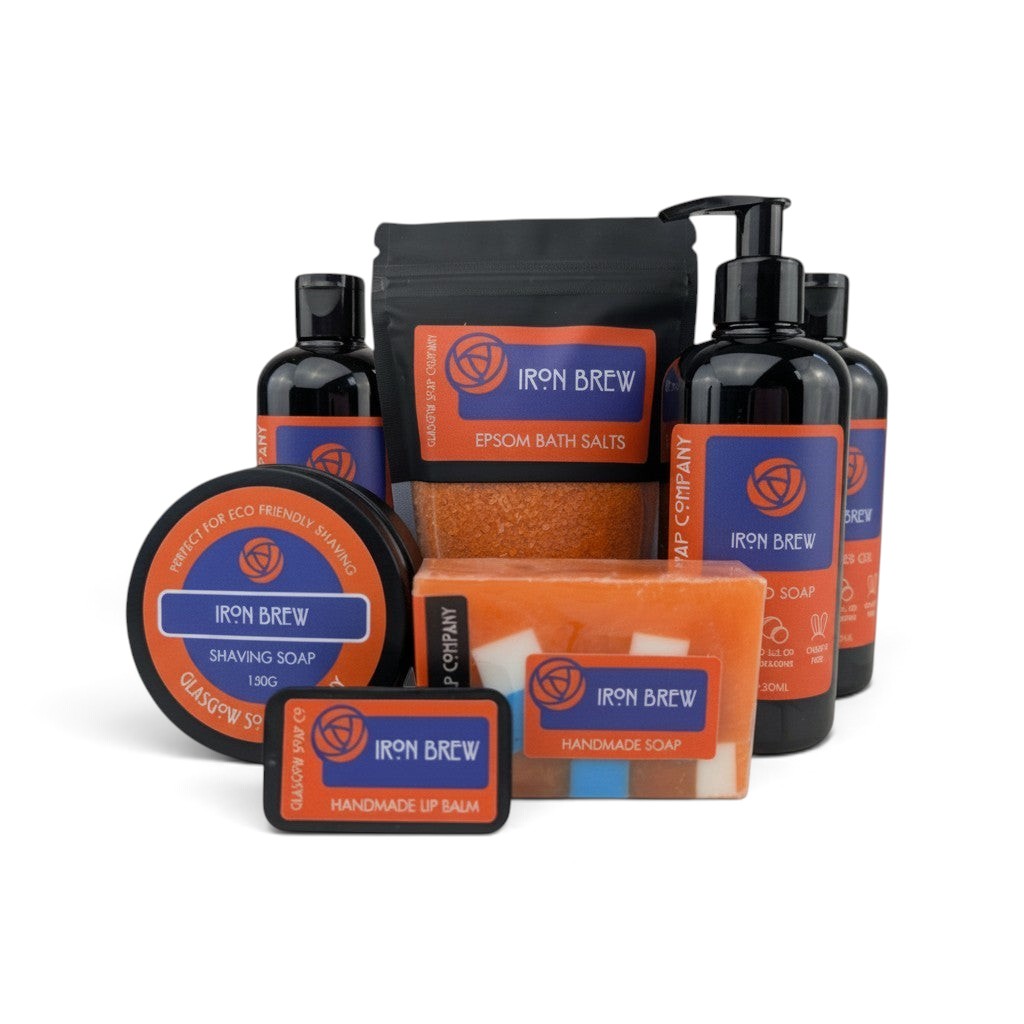 Glasgow Soap Company Ltd Iron Brew bath and body collection featuring orange soaps, bath salts, and liquid soap.