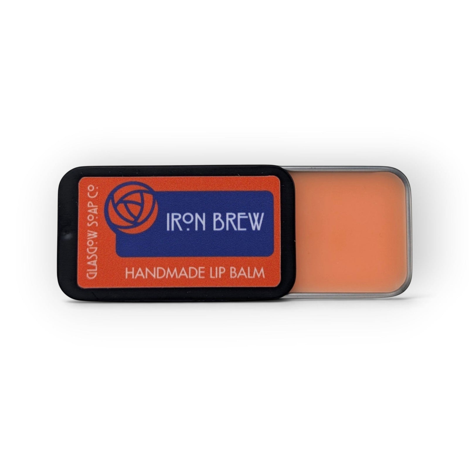 Glasgow Soap Company Ltd Iron Brew lip balm in a sliding metal tin with orange balm and Scottish-inspired branding.