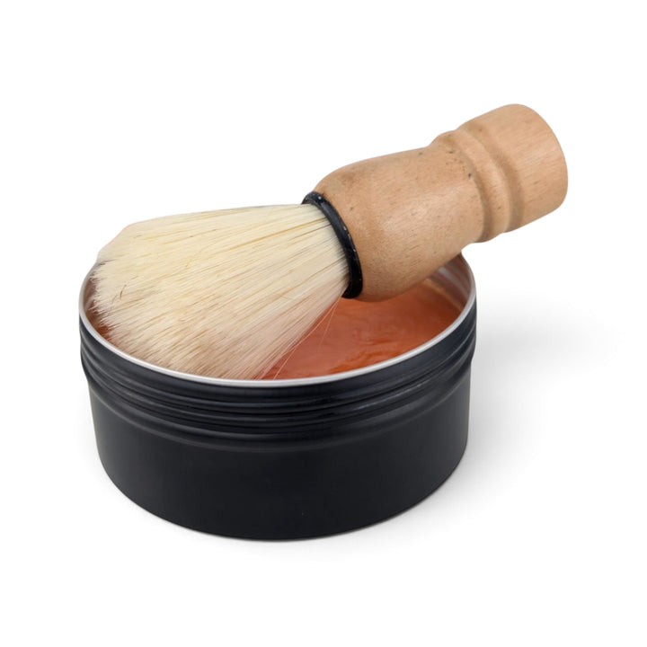 Glasgow Soap Company Ltd Iron Brew shaving soap in a black tin with a wooden handled vegan shaving brush