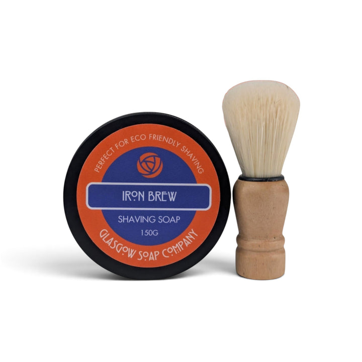Glasgow Soap Company Ltd Iron Brew shaving soap in a black tin with a wooden vegan shaving brush on a white background