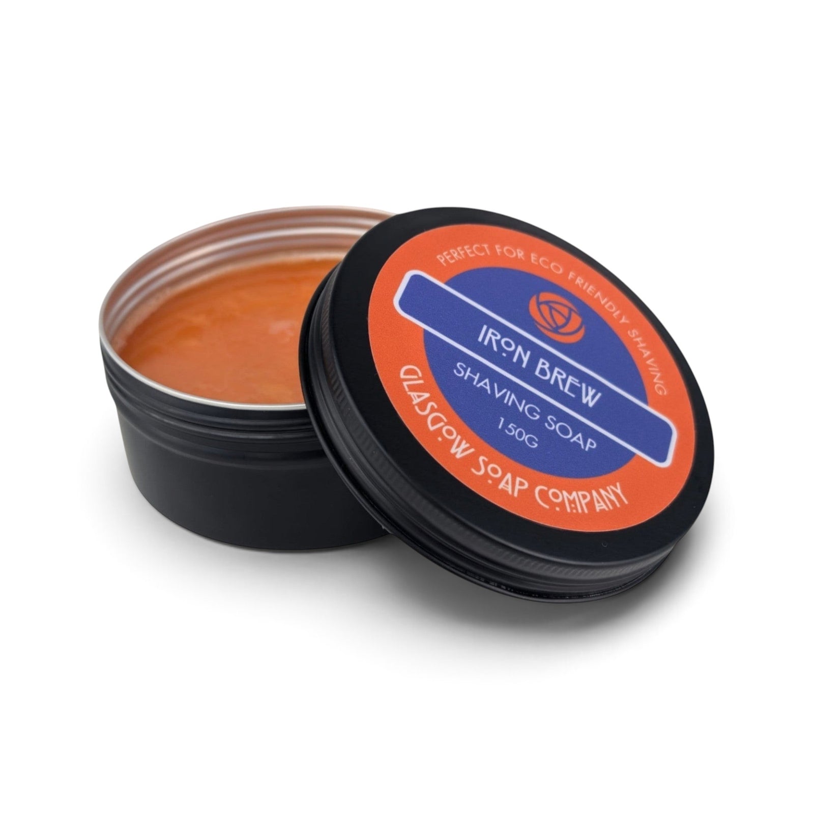 Glasgow Soap Company Ltd Iron Brew shaving soap in a black aluminium tin with orange citrus scented soap inside
