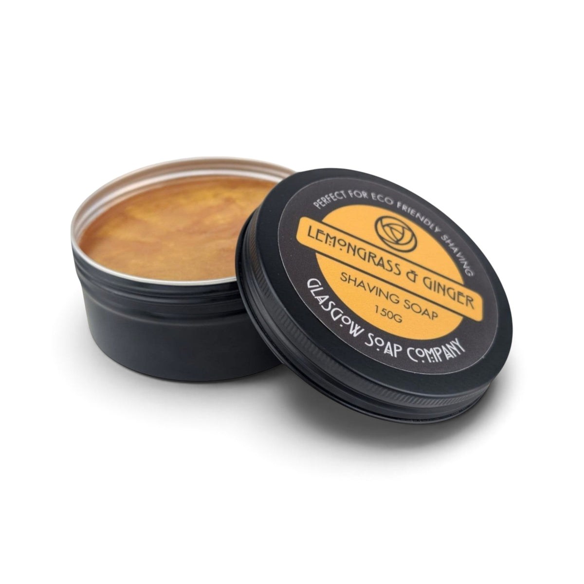 Glasgow Soap Company Ltd Lemongrass & Ginger shaving soap in a recyclable black aluminium tin with lid removed.