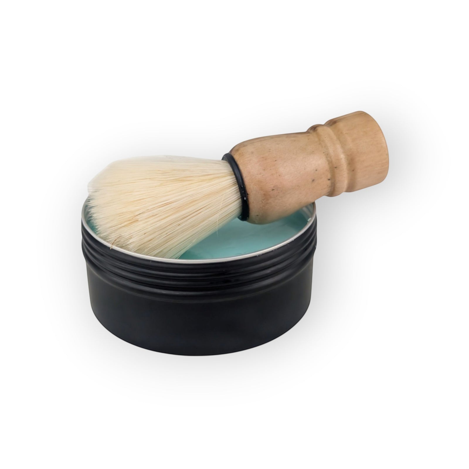 Glasgow Soap Company Ltd meditation shaving soap in a black tin with a wooden handled shaving brush.