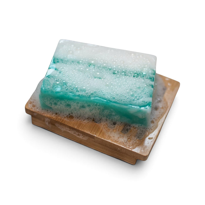 Glasgow Soap Company Ltd Meditation soap bar with white lather on a wooden soap dish