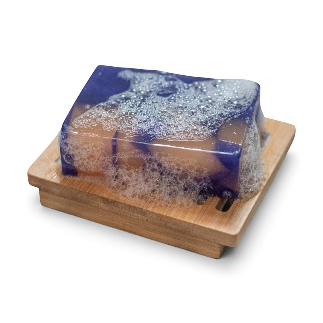Glasgow Soap Company Ltd handmade mulled wine soap bar with lather on a wooden soap dish