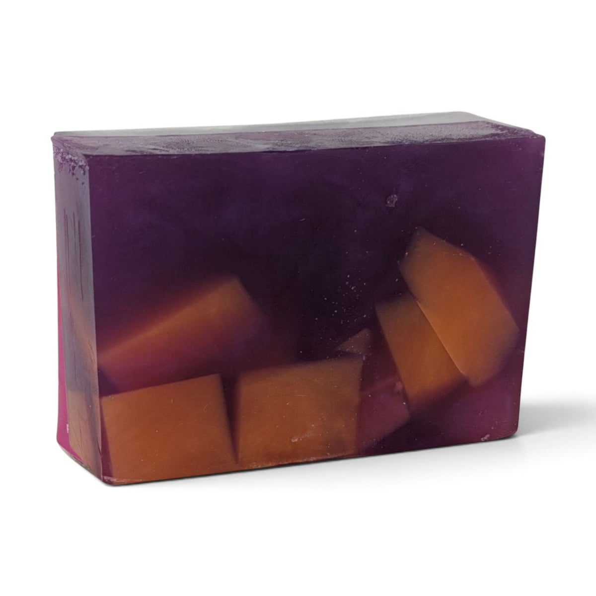 Glasgow Soap Company Ltd Mulled Wine soap bar with deep purple translucent base and orange fruit-like embeds.