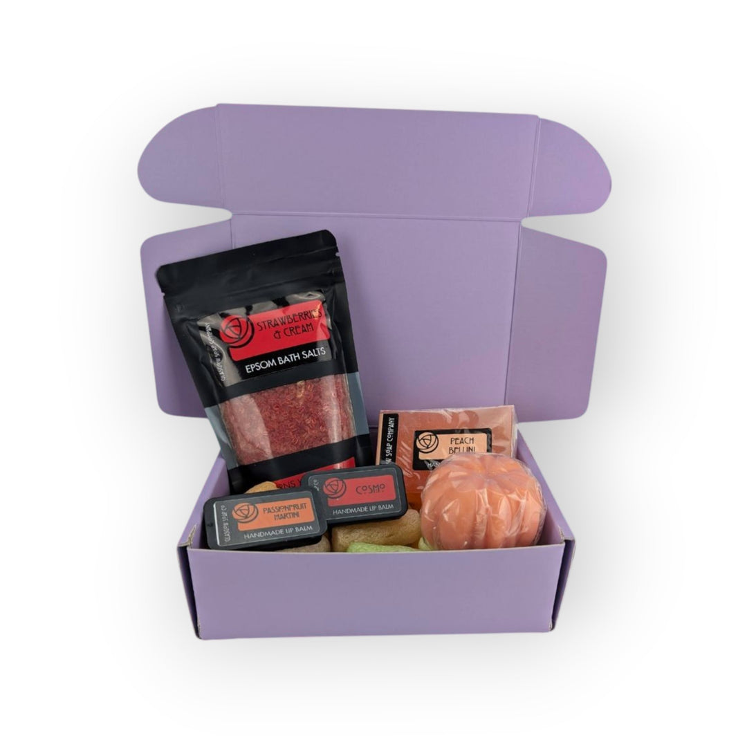 Glasgow Soap Company Ltd limited edition mystery box with strawberry &amp; cream bath salts, peach bellini powder, lip balms, and bath bomb.