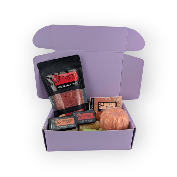 Glasgow Soap Company Ltd limited edition mystery box with strawberry &amp; cream bath salts, peach bellini powder, lip balms, and bath bomb.