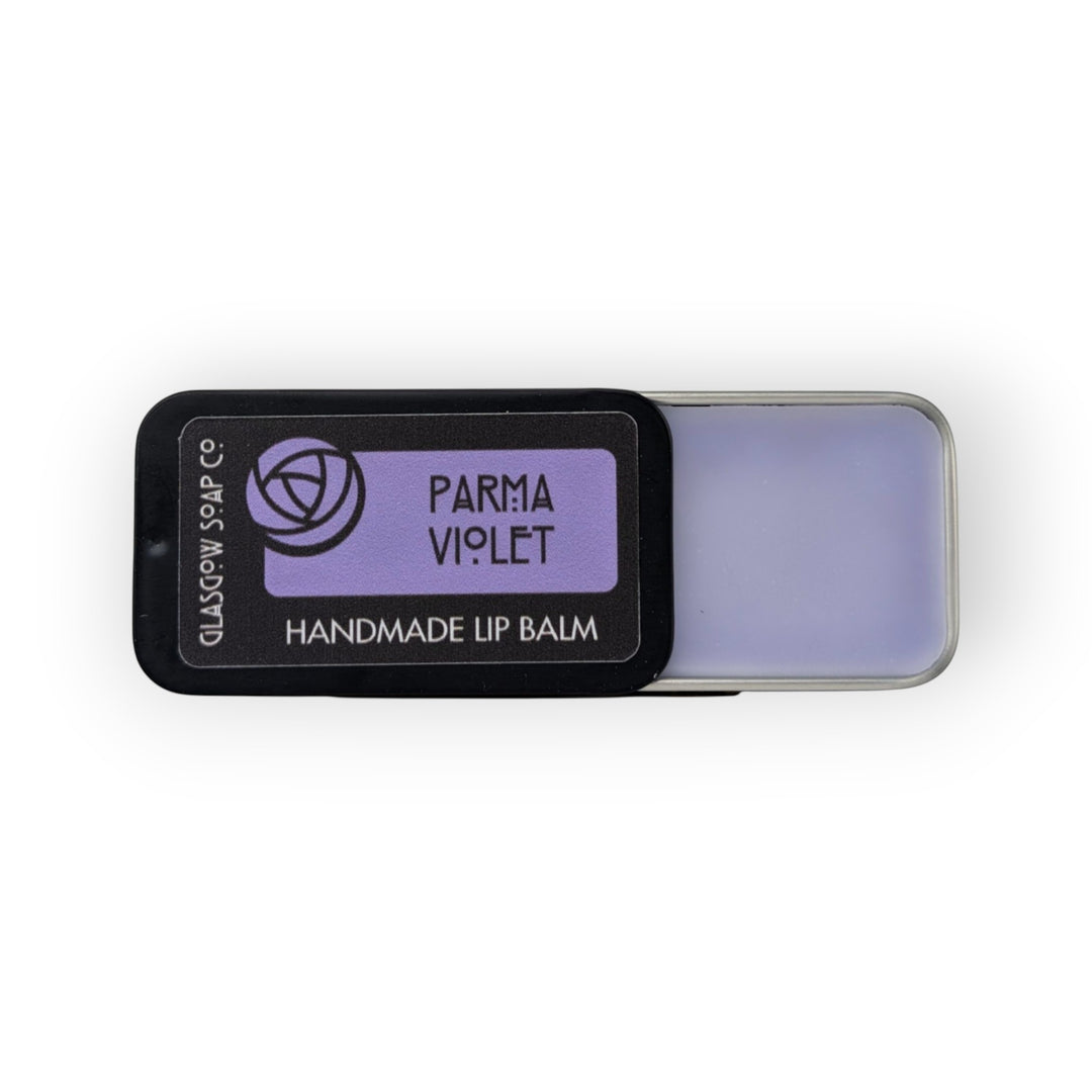 Glasgow Soap Company Ltd Parma Violet handmade lip balm in a black tin with a light purple balm.