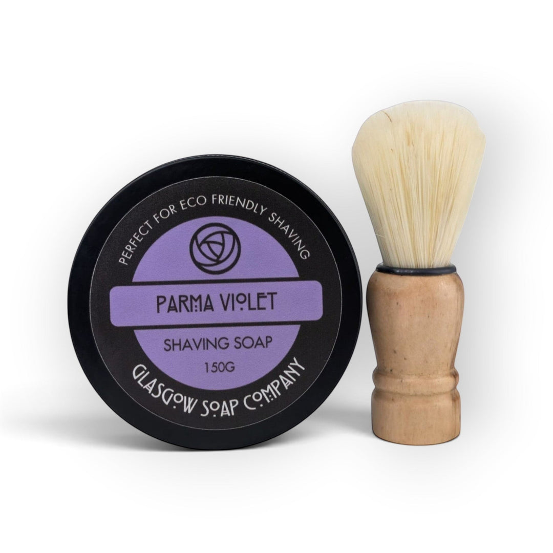 Glasgow Soap Company Ltd Parma Violet shaving soap in a black tin with a wooden vegan shaving brush