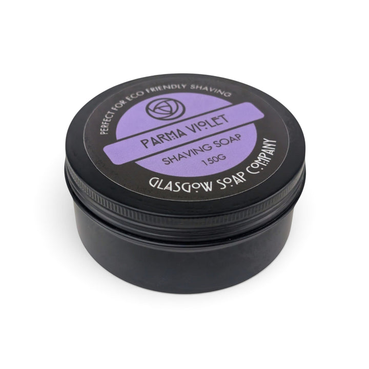 Glasgow Soap Company Ltd Parma Violet shaving soap in a black circular tin with a purple label, isolated on white.