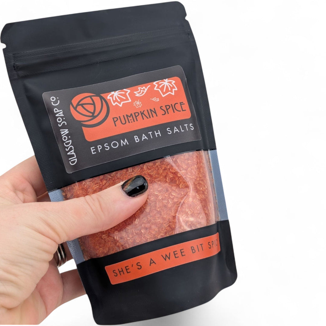 Glasgow Soap Company Ltd Pumpkin Spice Epsom bath salts in a recyclable black sachet held in a hand