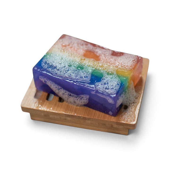 Glasgow Soap Company Ltd rainbow Scottish Pride soap bar with bubblegum scent on a wooden soap dish