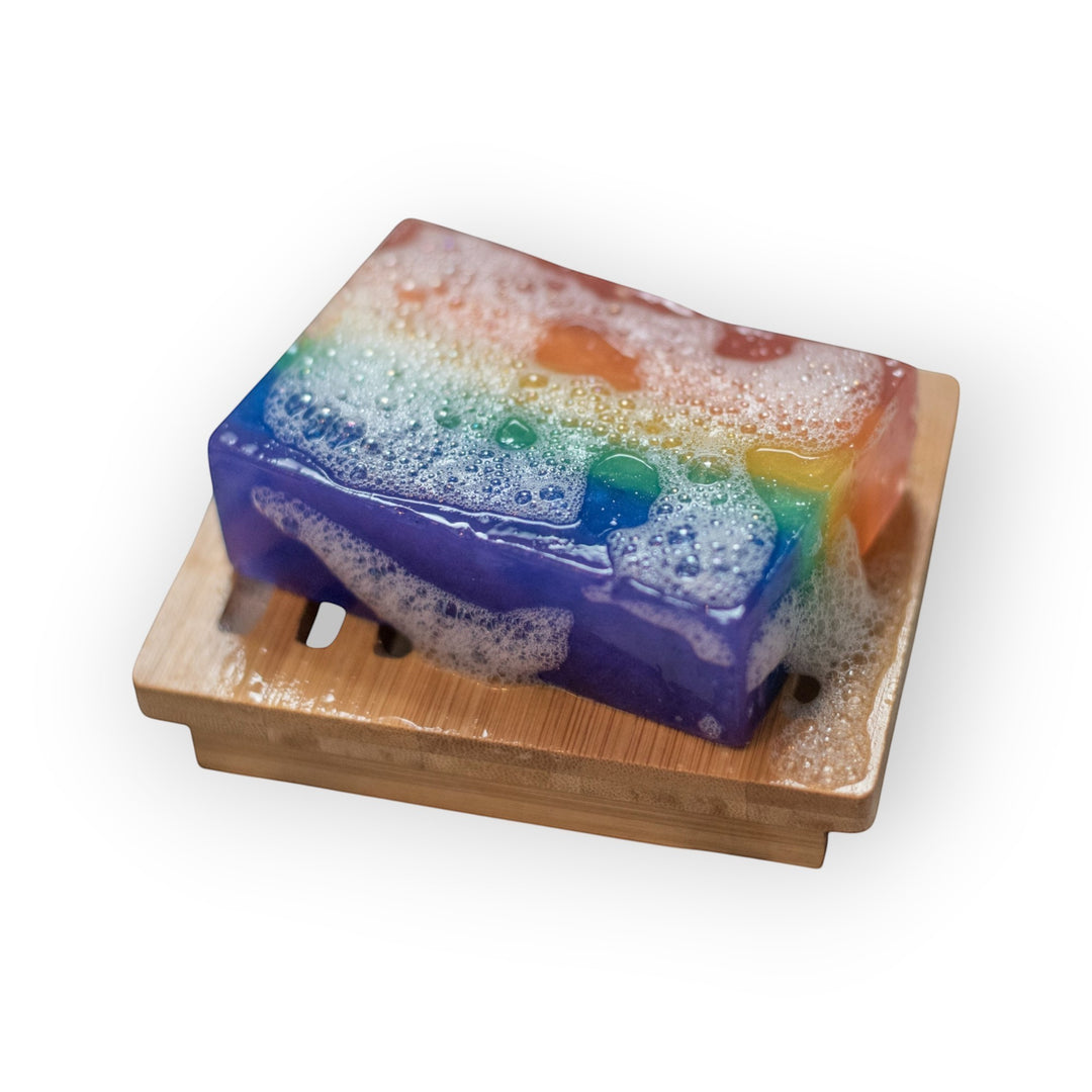Glasgow Soap Company Ltd Scottish Pride rainbow soap bar with bubblegum scent on a bamboo soap dish.