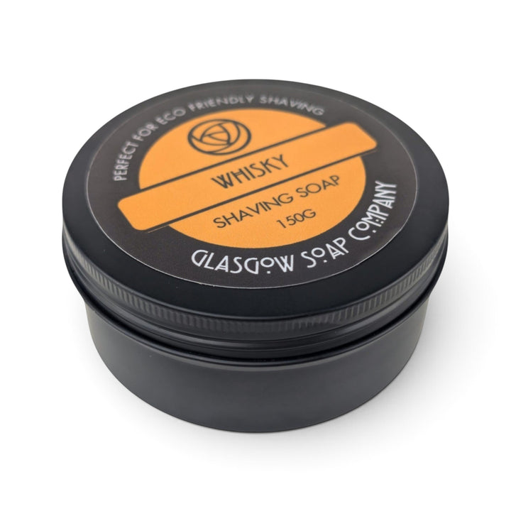 Glasgow Soap Company Ltd whisky scented shaving soap in a black metal tin with an orange label